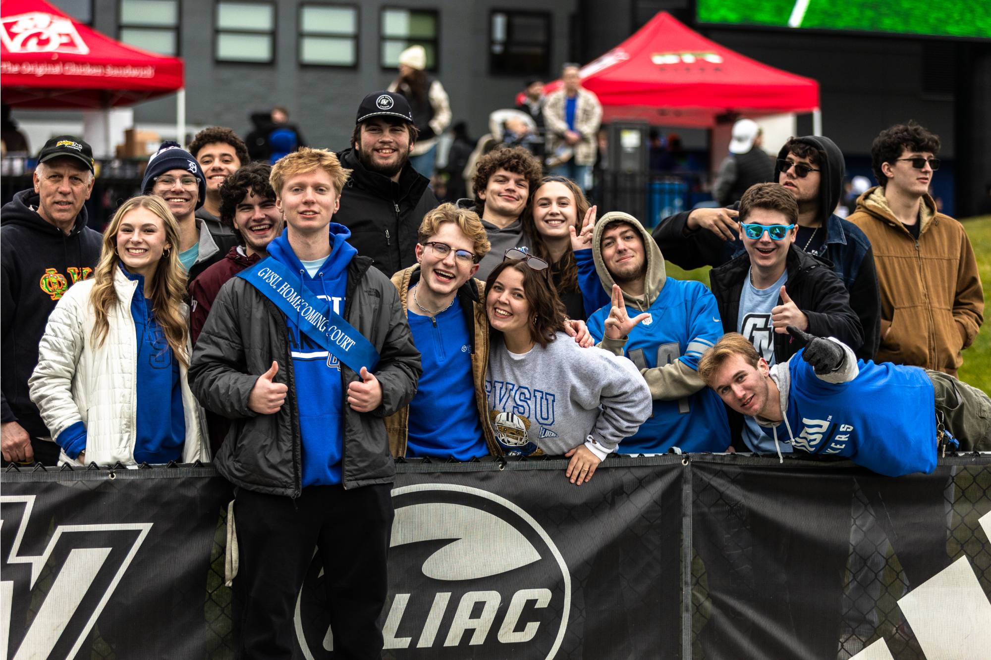 students pose at football game